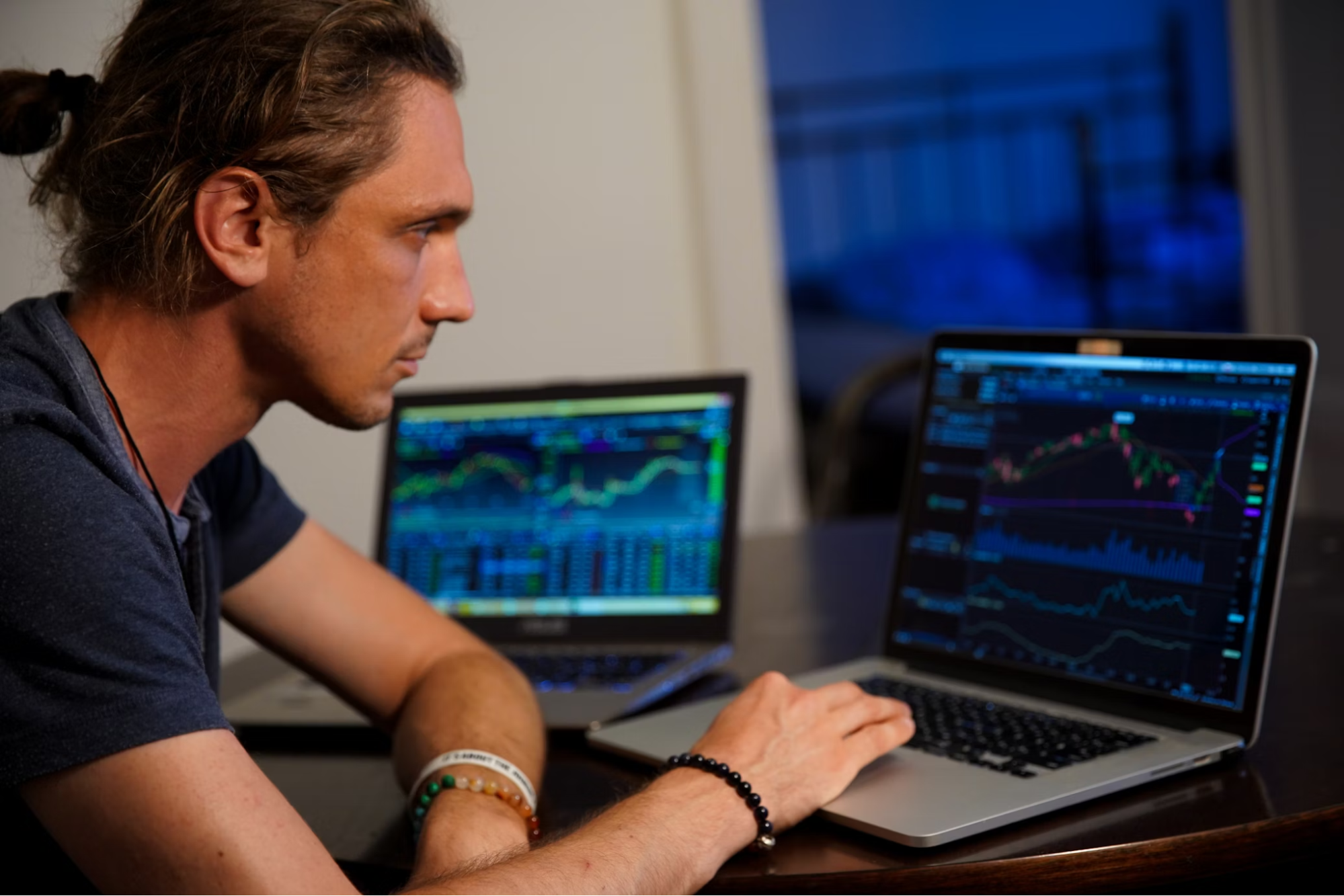 man analyzing charts and trends in stocks market in laptop screen